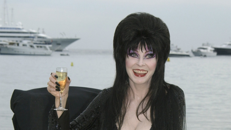 Elvira drinking champagne