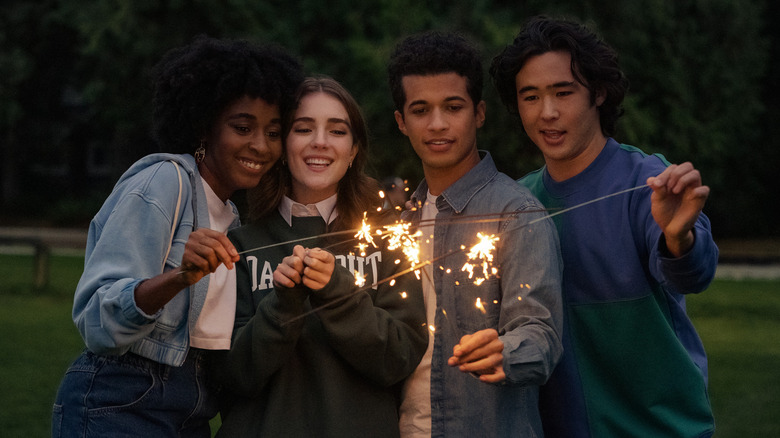 Stella, Clare, Aiden, and Scotty lighting sparklers