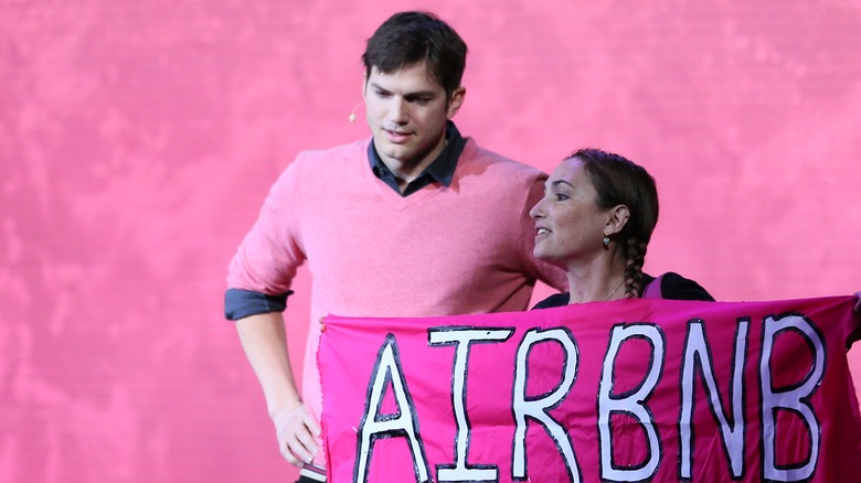 A protester interrupts Ashton Kutcher