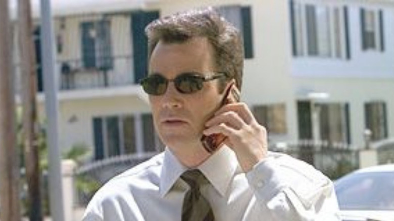 John Tenney wears black sunglasses