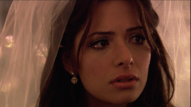 Carmen crying in wedding veil