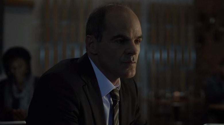 Doug Stamper contemplating at a table