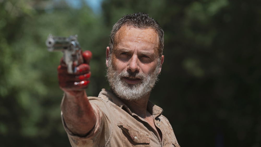 Rick Grimes aims his pistol