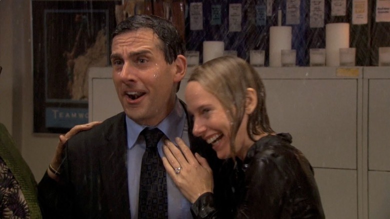 Michael Scott and Holly Flax laughing under sprinklers