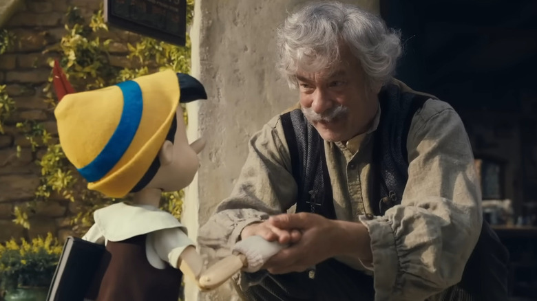 Geppetto encouraging Pinocchio before school