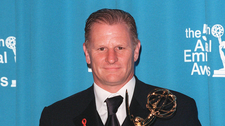 Gordon Clapp holding an Emmy award