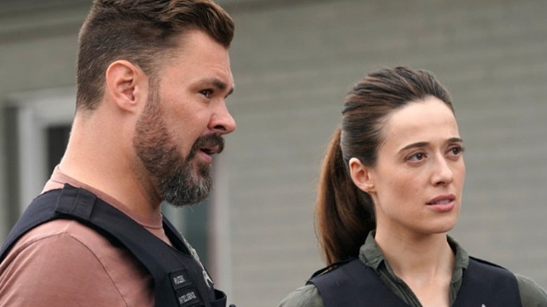 Patrick Flueger and Marina Squerciati looking to the right