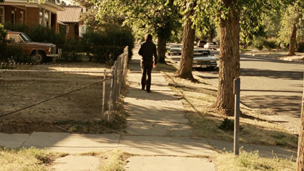 Javier Bardem as Anton Chigurh, fleeing on foot in 'No Country for Old Men'