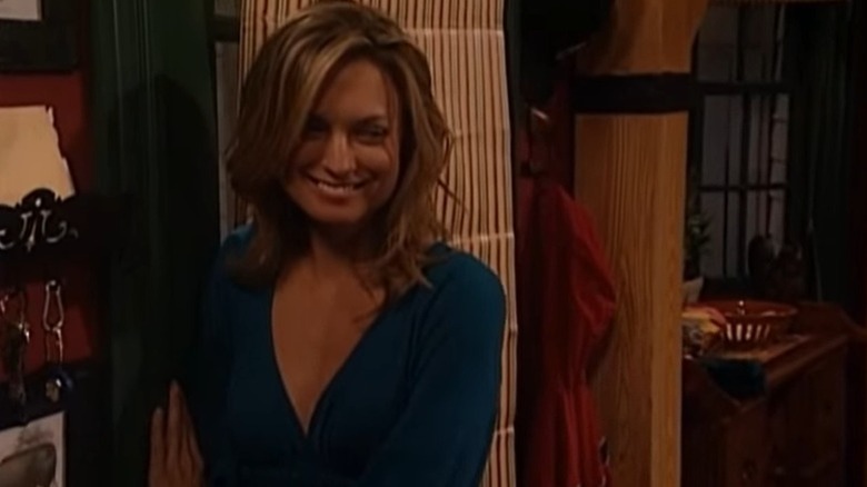 Cassie Layne smiles while holding the door