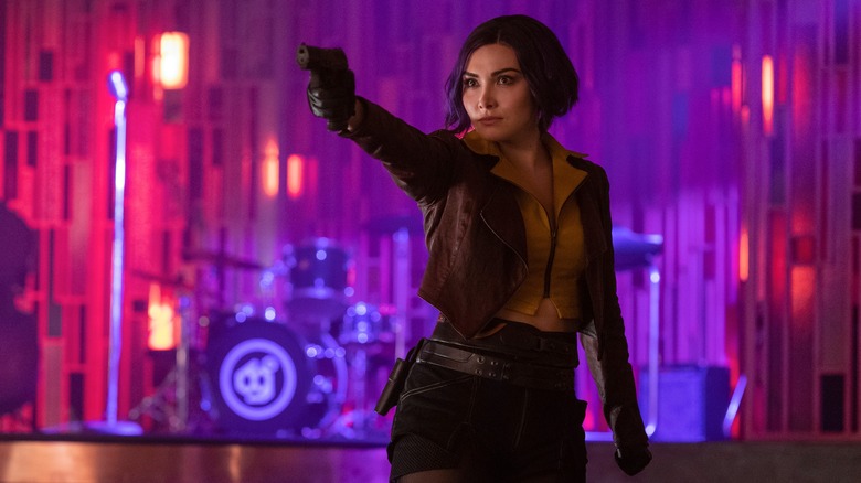 Daniella Pineda as Faye Valentine holding gun in Cowboy Bebop