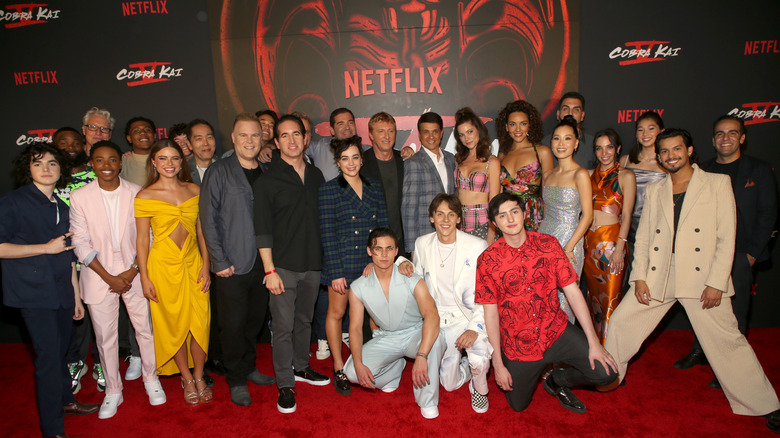 Dallas Dupree Young poses with Cobra Kai family