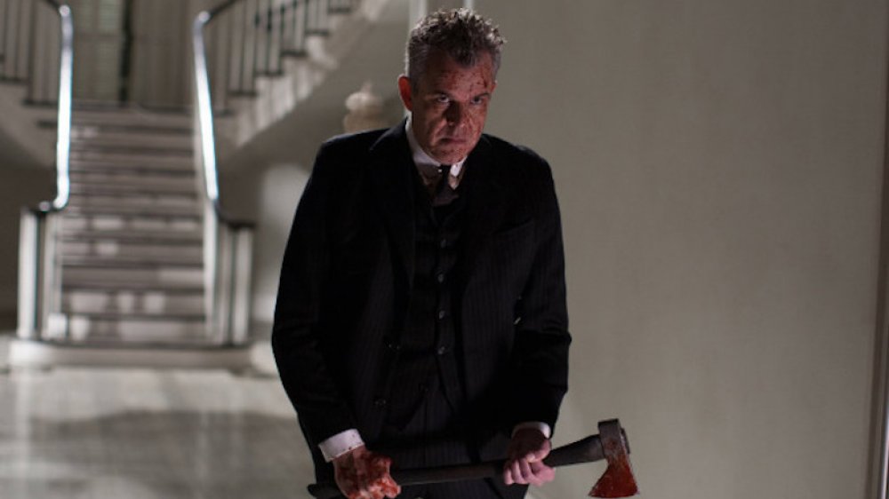 Danny Huston wielding a hatchet in American Horror Story 