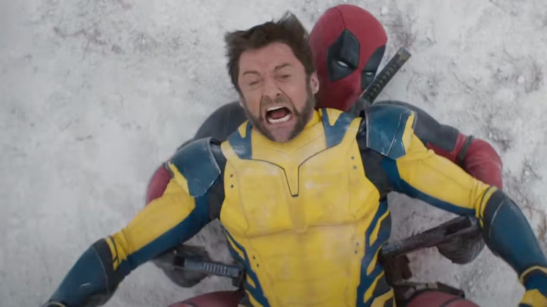 Wolverine on top of Deadpool mid-fight