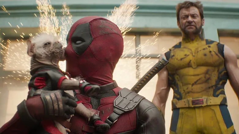 Deadpool holding Dogpool in front of Wolverine