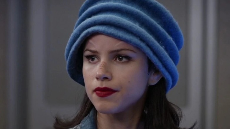 Alara Kitan wearing a blue ridged hat to hide her ears in 