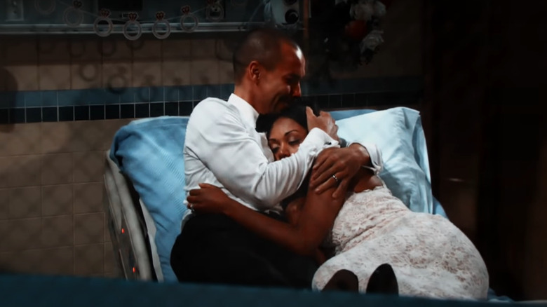 Devon holds Hilary Curtis in the hospital