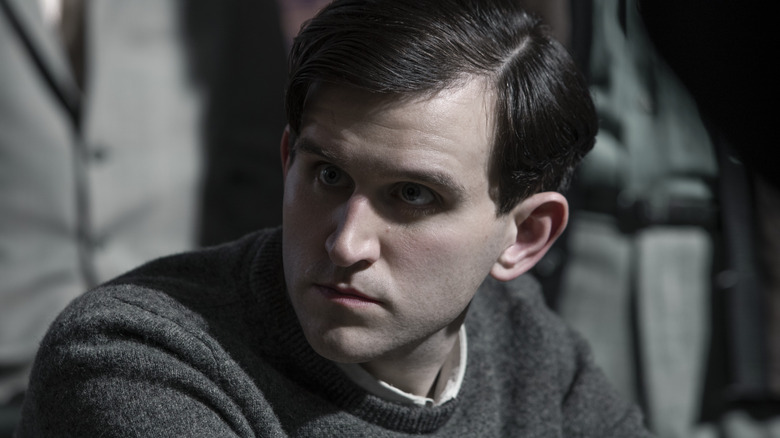 Harry Melling playing chess