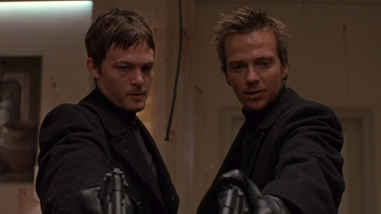 Connor and Murphy MacManus pointing guns