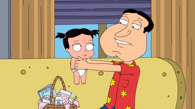 Quagmire nervously holding baby 