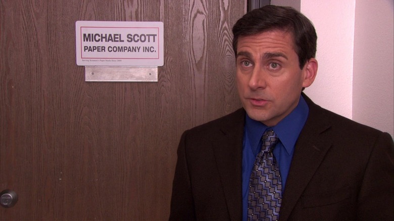 Michael outside his new office door