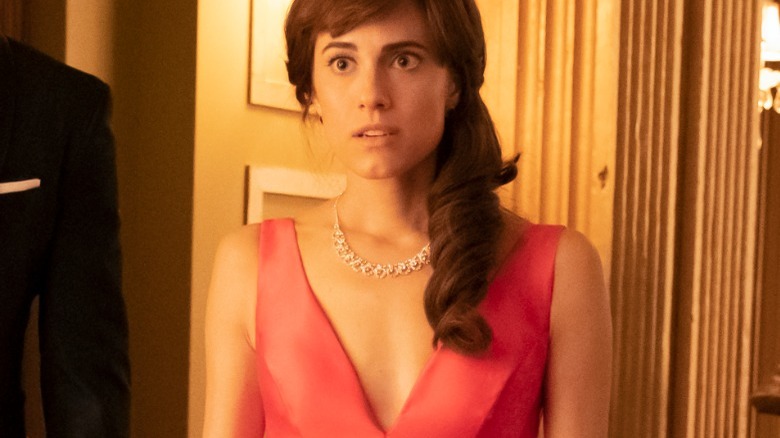 Kit looking surprised wearing a pink dress and diamond necklace