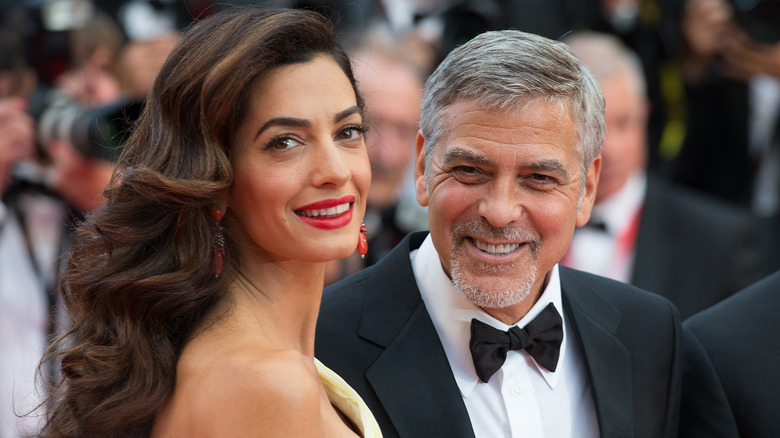 George and Amal Clooney in front of photographers