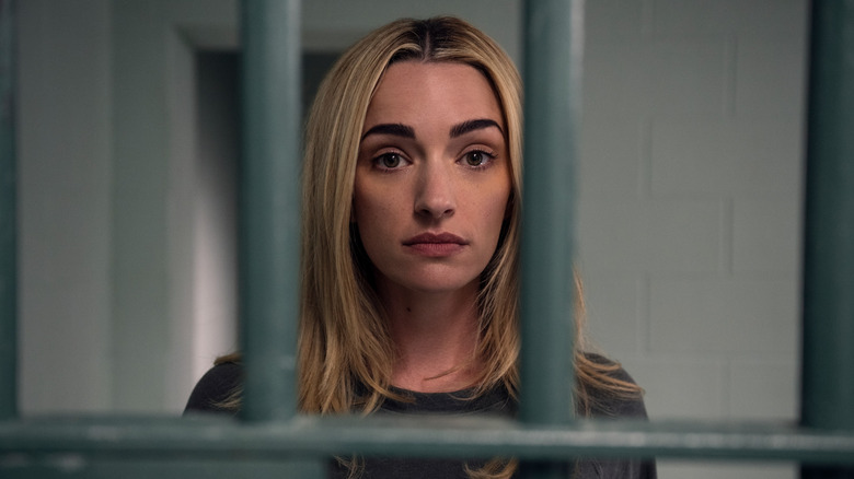 Georgia standing behind the bars of a jail cell in "Ginny & Georgia."