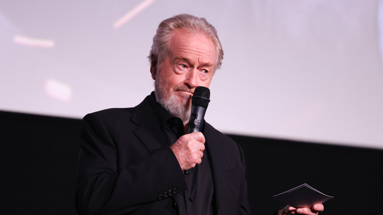 Ridley Scott holds microphone