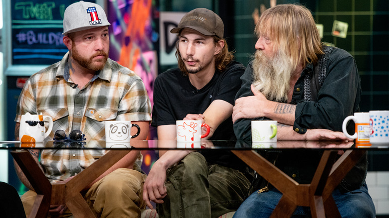 Rick Ness, Parker Schnabel, and Tony Beets sit with coffee