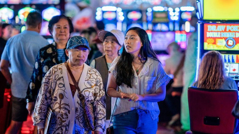 Awkwafina walking through a casino 