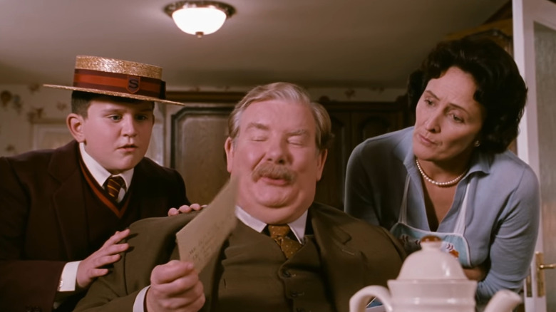 Dudley, Vernon, and Petunia inspecting Harry's letter