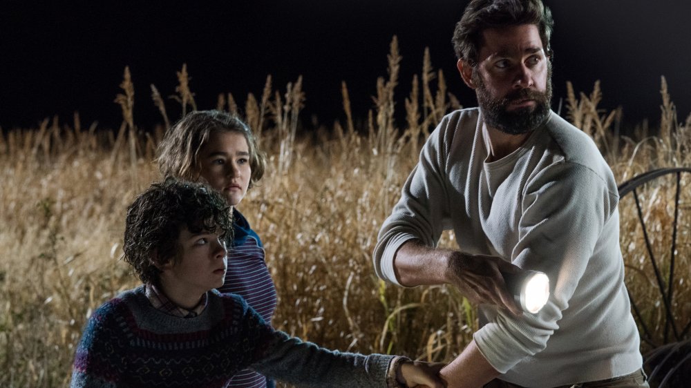 Noah Jupe, John Krasinski, and Millicent Simmonds in A Quiet Place