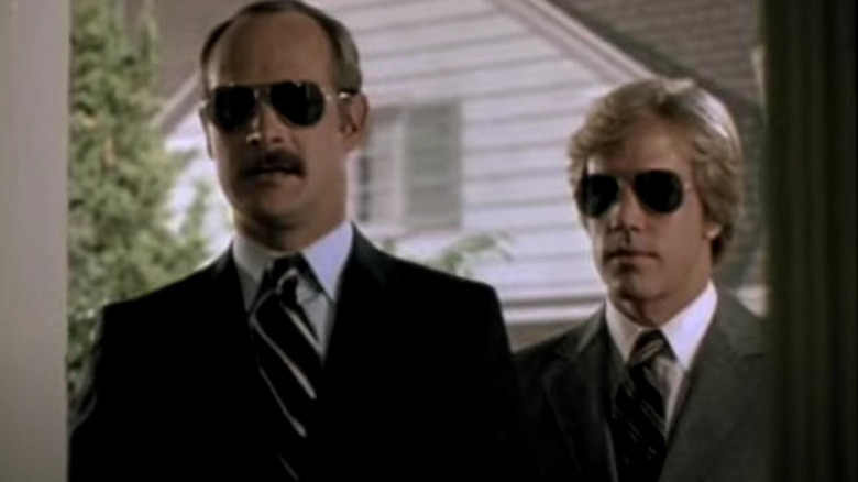 Rick and A.J. Simon wearing suits and sunglasses