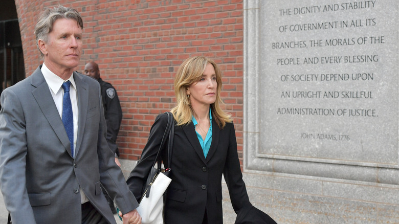 Felicity Huffman walking holding hands