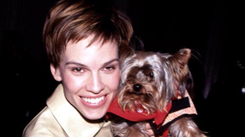 HIlary Swank holding a dog