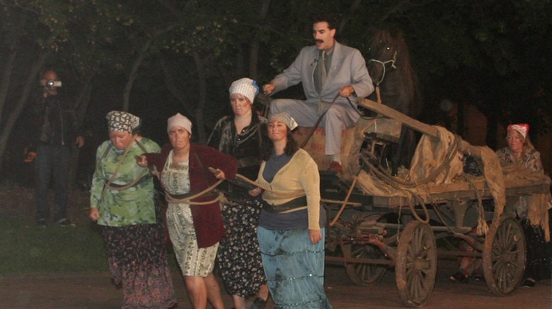 Women pulling Borat in wagon