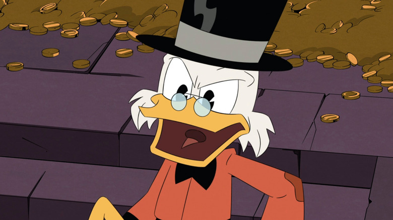 Scrooge McDuck sits by a gold pile