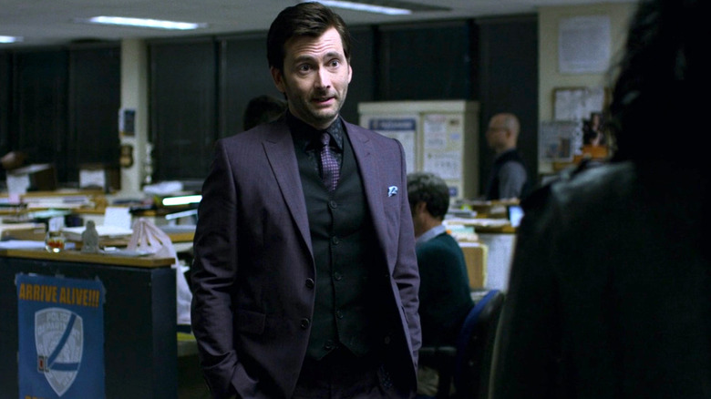 Kilgrave stands in a police station