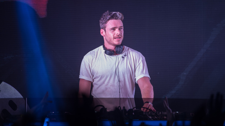 Richard Madden in white T-shirt DJing in Ibiza