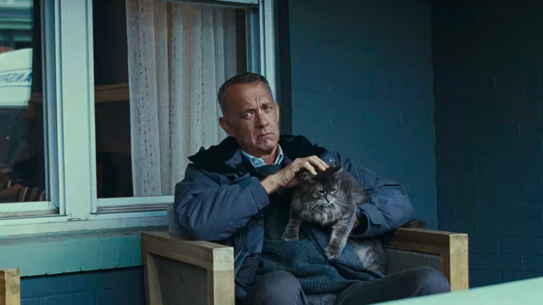 Otto sitting on porch with cat