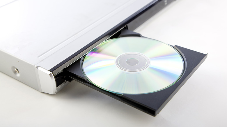 A DVD sits inside a disc player