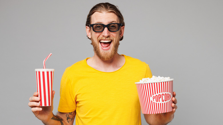 Happy man popcorn and drink