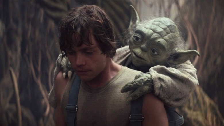 Luke carries Yoda on his back