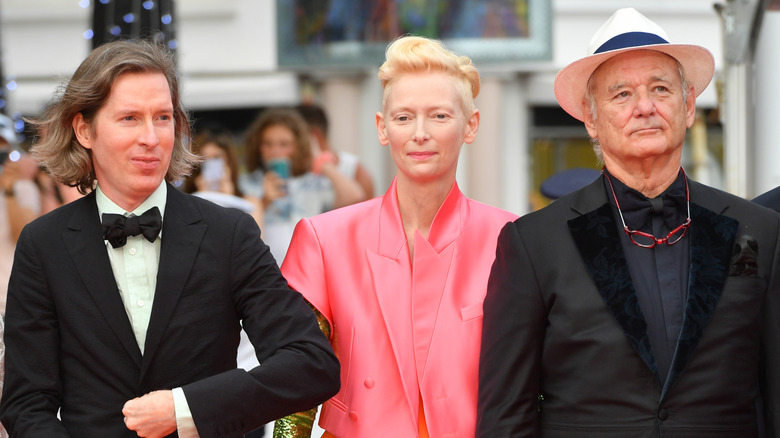 Wes Anderson, Tilda Swinton, and Bill Murray stand next to each other