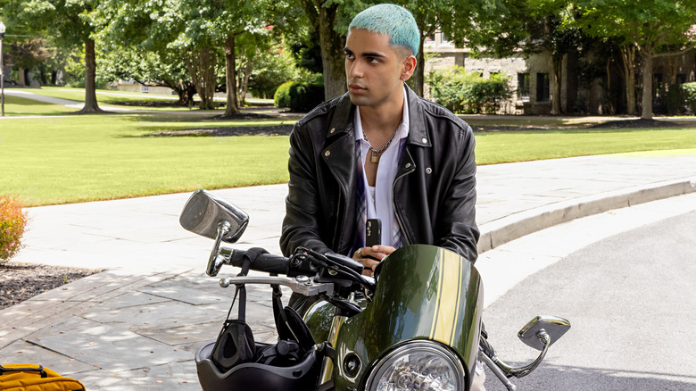 Russ standing on a motorcycle 