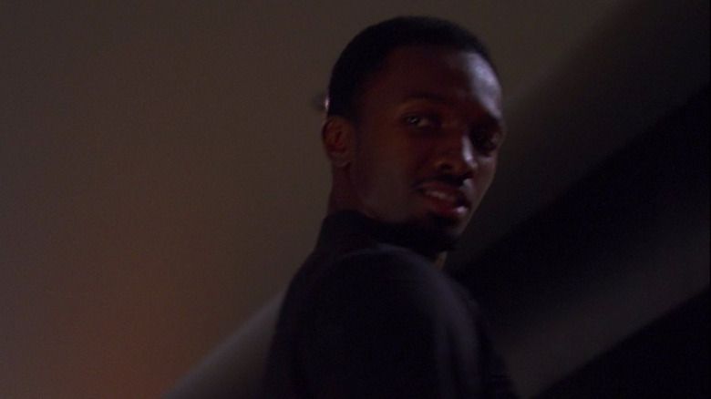 Jamie Hector looking over his shoulder