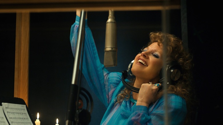 Tammy Faye sings in a recording booth