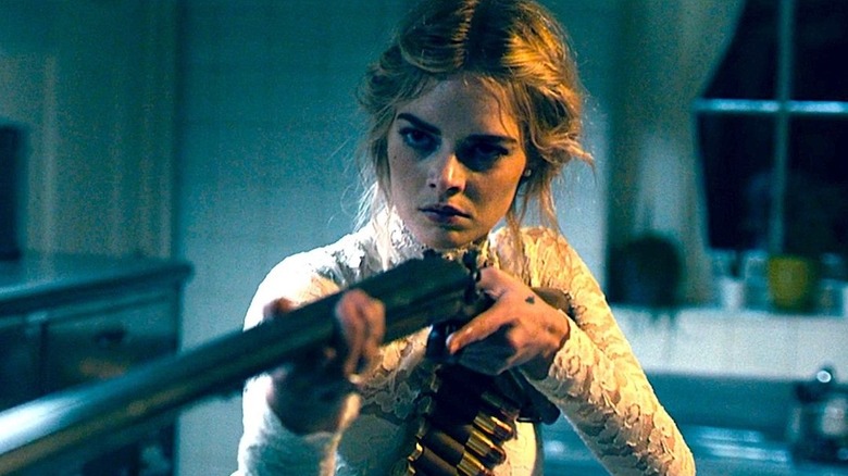 Samara Weaving aiming rifle