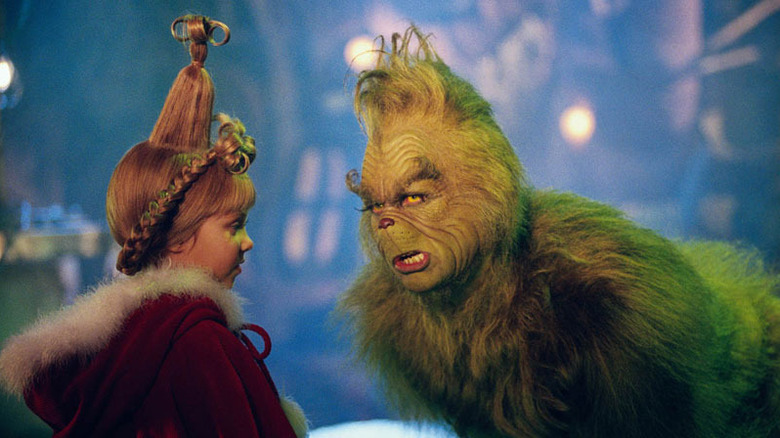 Grinch sneering at Cindy Lou Who