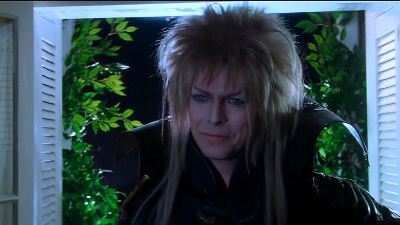 Jareth standing in front of open window 